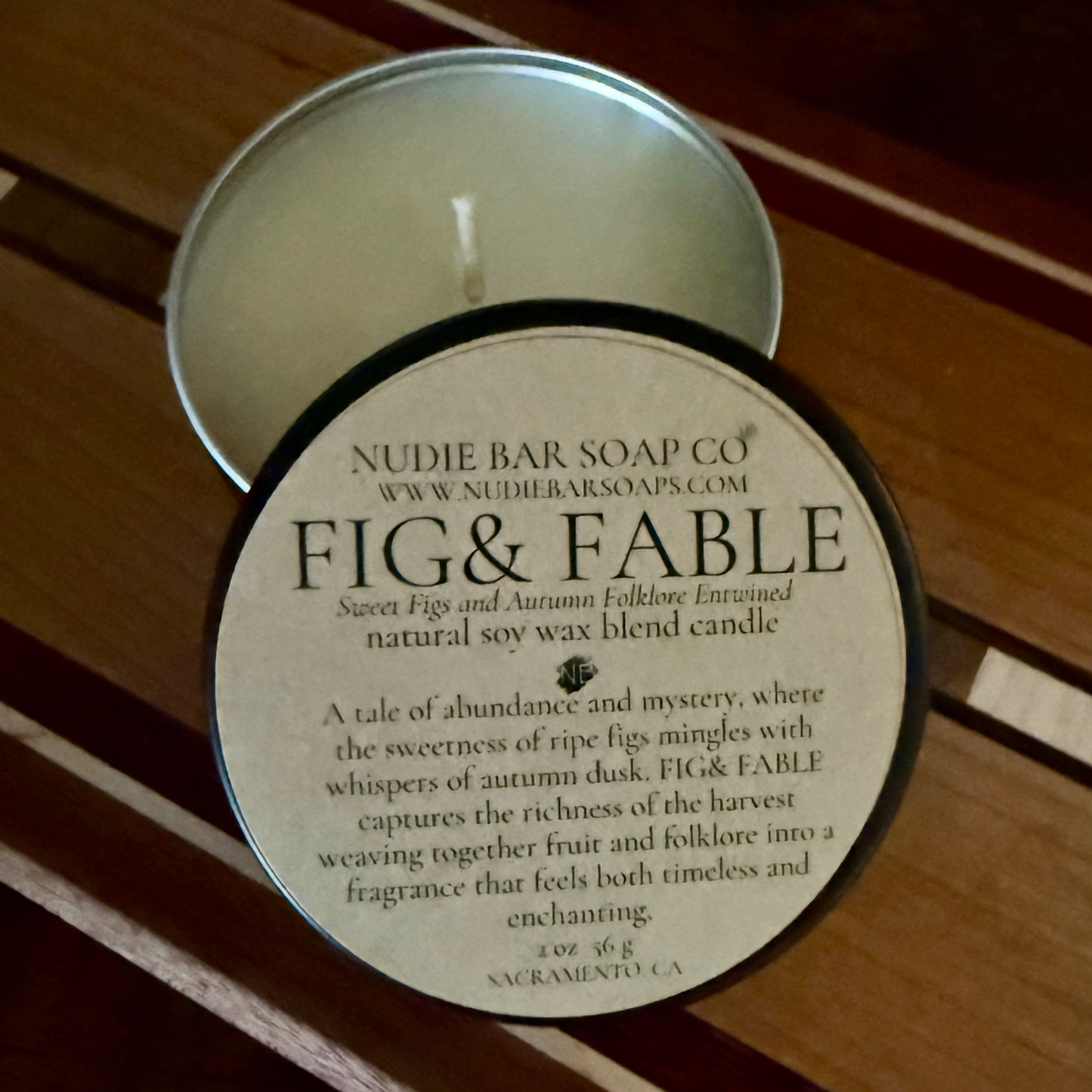 Nudie Bar Soap Co. Fig & Fable candle on a wooden surface
